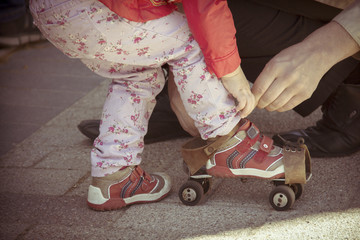 Old roller skates for infant girl. Old photo film styled picture