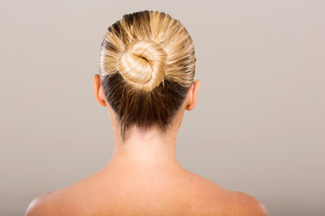 young woman with hair bun - obrazy, fototapety, plakaty