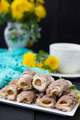 Cookies rolls with rhubarb and cinnamon on a dark background
