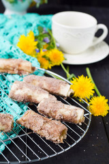 Cookies rolls with rhubarb and cinnamon on a dark background