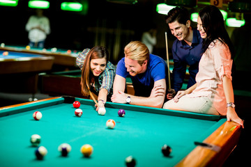 Young people playing pool