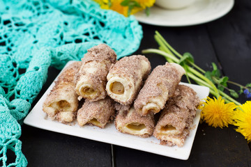 Cookies rolls with rhubarb and cinnamon on a dark background