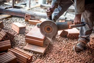 engineer working on cutting bricks at construction site