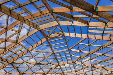 New wooden roof constructions on the blue  sky background