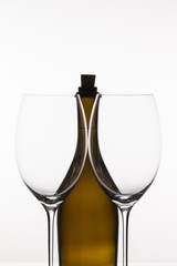 Two empty glasses of wine and brown bottle