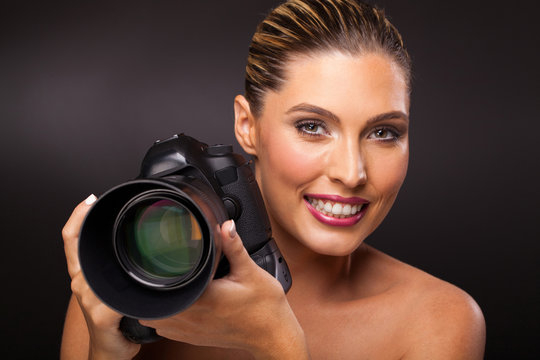 woman holding a digital SLR camera