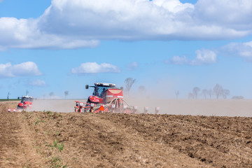 Fototapeta premium Tractor harrowing the field