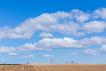 Tractor harrowing the field