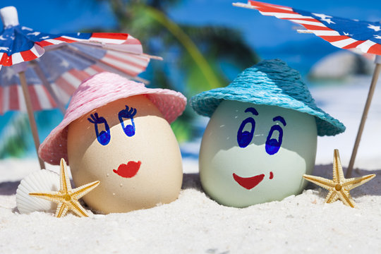 Happy eggs on ocean beach during patriotic holiday 