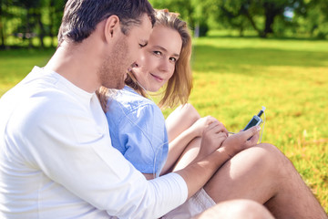 Tranquil Caucasian Couple Sitting Together Embraced On the Grass