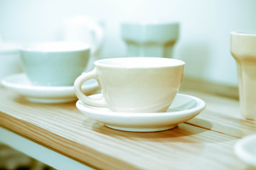 Fototapeta na wymiar Coffee cup on wooden shelf