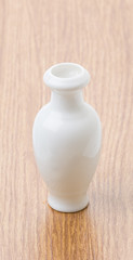 white vase on wood table