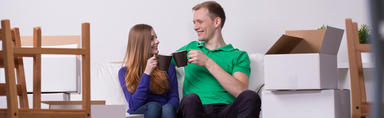 Couple drinking tea in new house