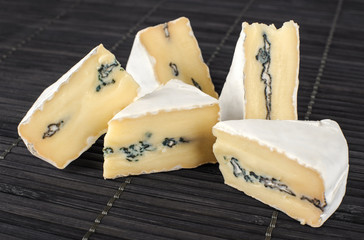 The cheese with a blue and a white mold