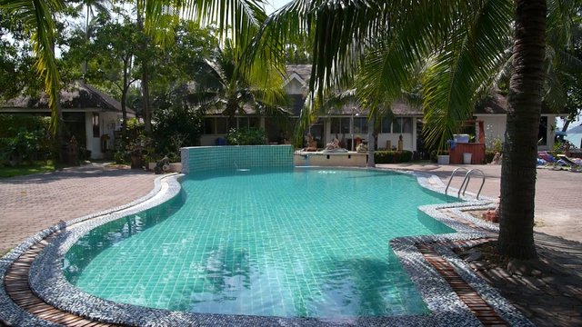 Tropical Swimming Pool in Luxury Resort on the Beach
