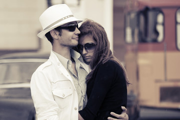 Young fashion couple in love on a city street