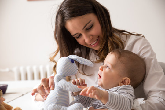 Mother And Her Baby Playing With Toys.