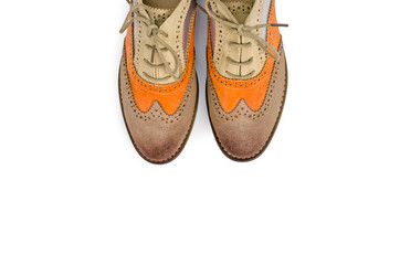Beautiful brown and orange woman shoes isolated on white backgro