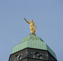 Fototapeta na wymiar Hercules statue on top of Town Hall tower in Dresden.