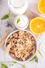 bowl of cereal with milk and orange