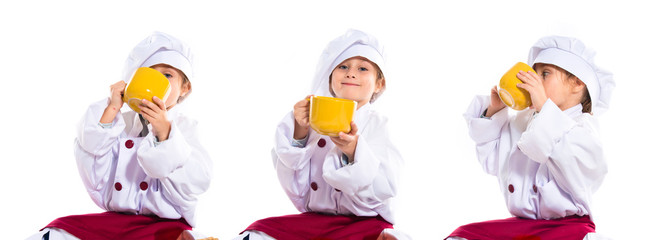 Girl dressed like chef holding a cup of coffee