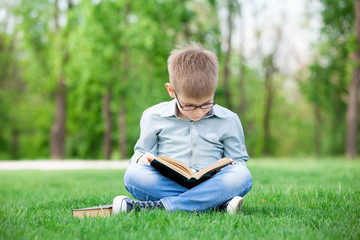 Happy young boy with a books