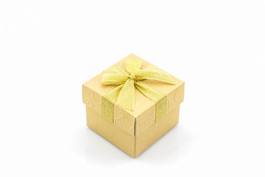 Golden gift box with ribbon bow .