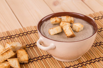 Pea soup with crouton close up.