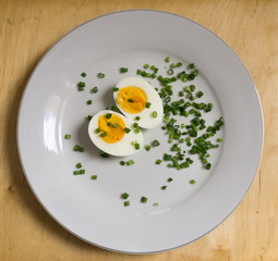 Boiled egg halves on a white plate