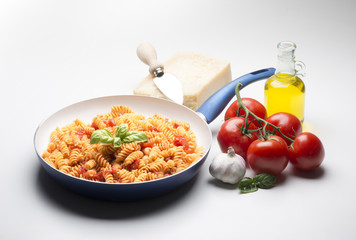 pan with macaroni and ingredients isolated on white background