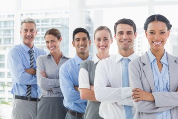 Happy business people looking at camera in a row 