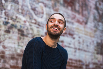 Handsome smiling and casual young man looking towards
