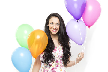 Attractive Young Smiling Brunette holding Colorful Balloons - 83637991