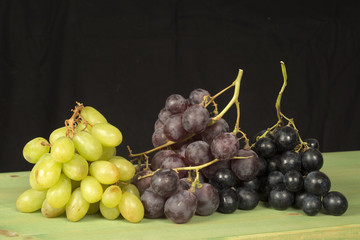 Grape fruit on green table with black background