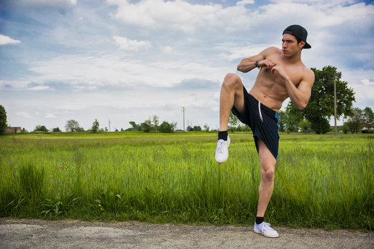Shirtless athletic young man outdoor practicing martial arts - Powered by Adobe
