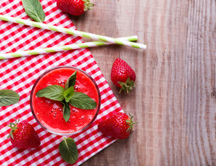 Strawberry smoothie on the wooden table