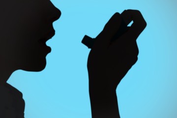 Composite image of close up of a woman using an asthma inhaler