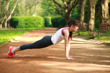 Sportive girl working out doing push ups press exercise