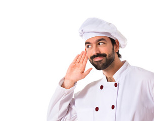 Chef listening over white background