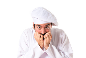 Frightened chef over white background
