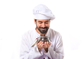 Chef holding jar glass with coffee beans inside