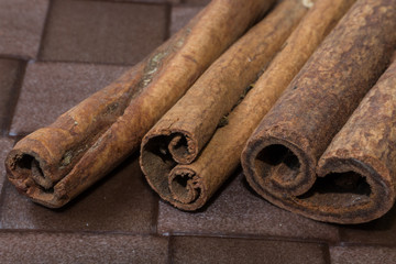 Cinnamon sticks close-up on brown background