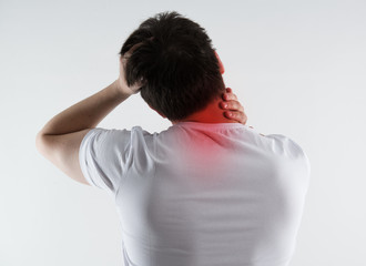 Young male massaging his neck in pain. Nape injury.  