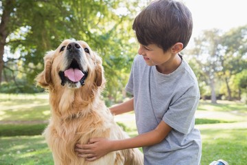 Little boy with his dog in the park