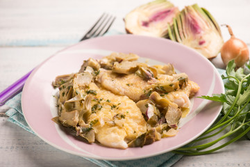 fillet fish with sauteed artichoke, selective focus