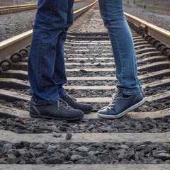Young couple kissing at railways rails