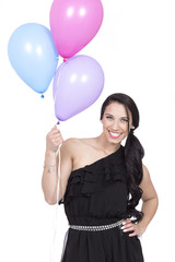 Attractive Young Smiling Brunette holding Colorful Balloons - 83643141