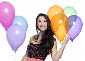 Attractive Young Smiling Brunette holding Colorful Balloons - 83643197