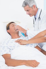 Fototapeta premium Doctor putting an oxygen mask