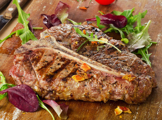 Steak with Fresh Herbs on a rustic wooden board